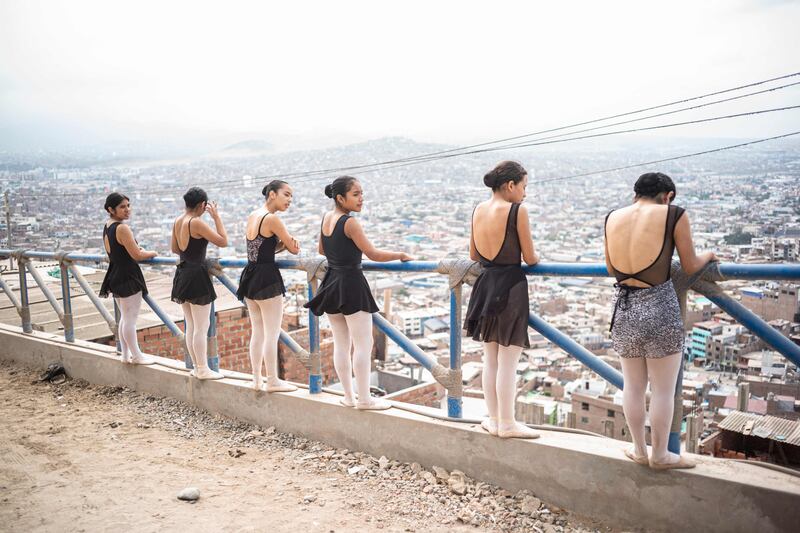 The students perform atop the hill in Chorrillos district