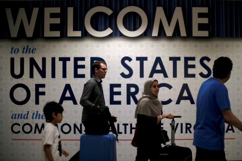 FILE PHOTO: International passengers arrive at Washington Dulles International Airport after the U.S. Supreme Court granted parts of the Trump administration's emergency request to put its travel ban into effect later in the week pending further judicial review, in Dulles, Virginia, U.S., June 26, 2017. REUTERS/James Lawler Duggan/File Photo
