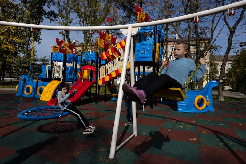 Alla, 12, has a swinging time in Balakiya, Ukraine, as life goes on despite the war. Getty Images