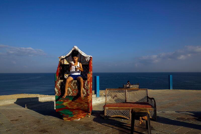 A Palestinian boy sits near the beach in Gaza City. Mohammed Abed / AFP Photo