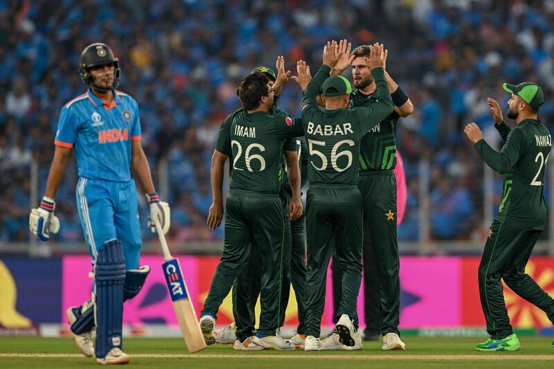 Pakistan's Shaheen Afridi celebrates with teammates after taking the wicket of India's Shubman Gill, left. AFP