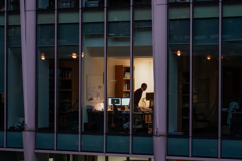 A worker in an office in London's financial district. Many people will start the year working from home amid government concerns about the spread of the Omicron coronavirus strain. AP