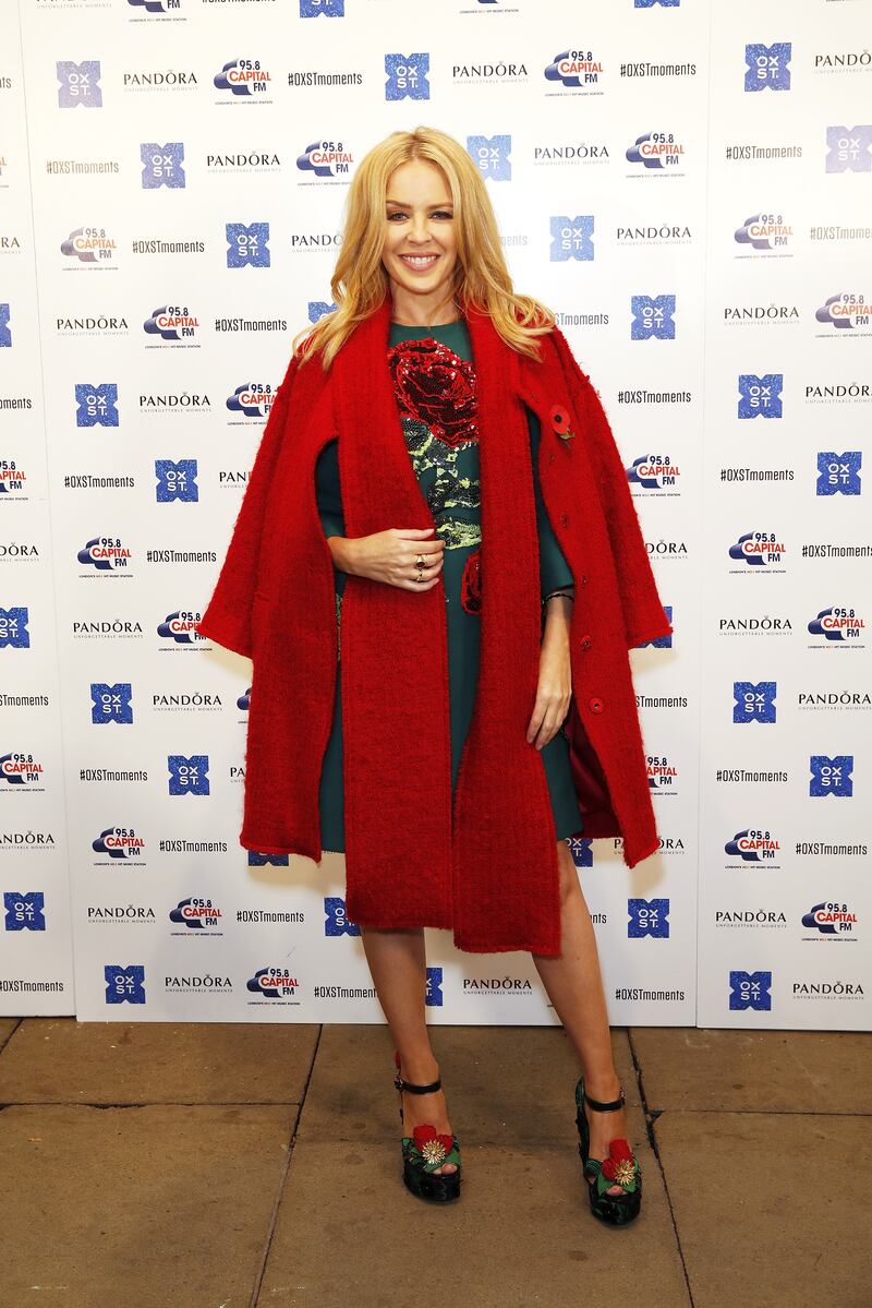 Kylie Minogue, in a red wool cape, turns on the Oxford Street Christmas lights at the Pandora flagship store on November 1, 2015 in London, England.