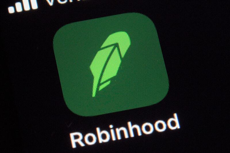 A logo for share trading app Robinhood on a smartphone. The company added more than 4 million new users in the three months to June 30 due to "exceptionally strong interest" in trading, particularly cryptocurrencies. AP Photo