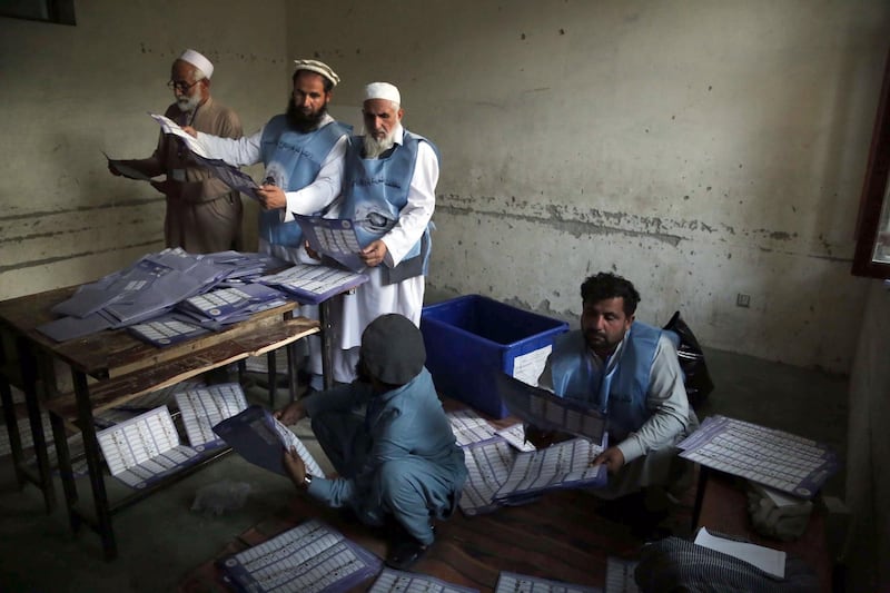 epaselect epa07107112 Workers of Independent Election Commission (IEC) count votes at a polling station after parliamentary elections in Jalalabad, Afghanistan, 20 October 2018. At least five people were killed and 118 injured as a series of violent attacks and explosions hit Afghanistan, mainly the capital Kabul and the northern province of Kunduz, as parliamentary elections got underway. Around 8.8 million Afghans, 34 percent of them women, voted on 20 October to elect 250 lawmakers to the country's lower house of Parliament.  EPA/GHULAMULLAH HABIBI