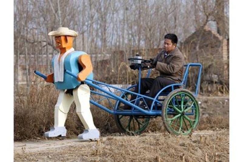 The Chinese inventor, Wu Yulu, whose creations are constructed using scrap metal, operates his robot-powered rickshaw. Reinhard Krause / Reuters