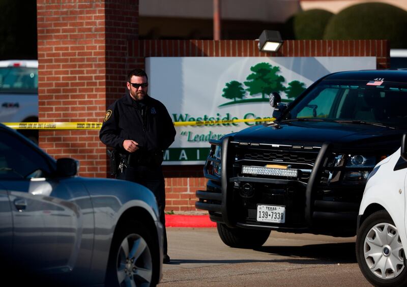 An officer stands near the scene after a church shooting at West Freeway Church of Christ on Sunday, Dec. 29, 2019 in White Settlement, Texas. (Juan Figueroa/The Dallas Morning News via AP)