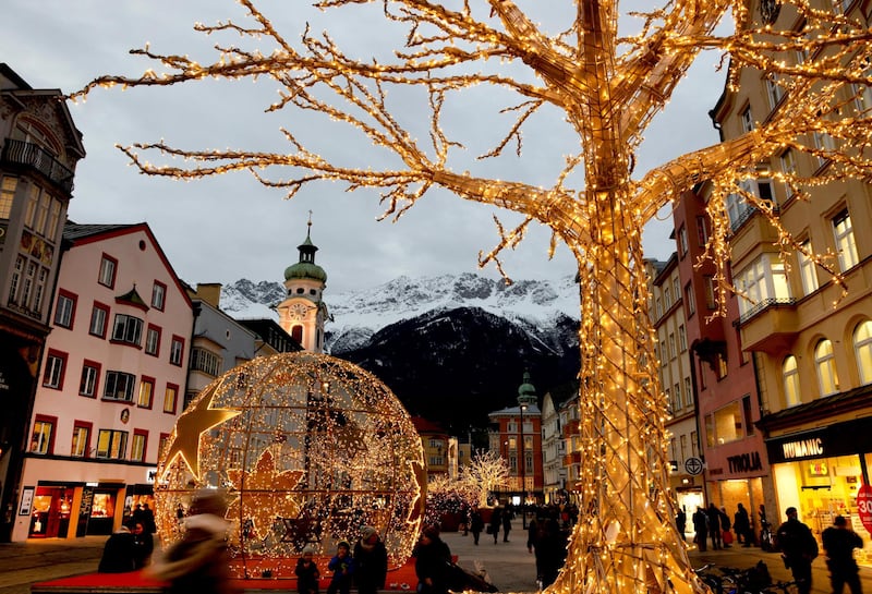 People pass by the Christmas illuminations, as the outbreak of the coronavirus disease (COVID-19) continues, in Innsbruck, Austria December 15, 2020. REUTERS/Leonhard Foeger