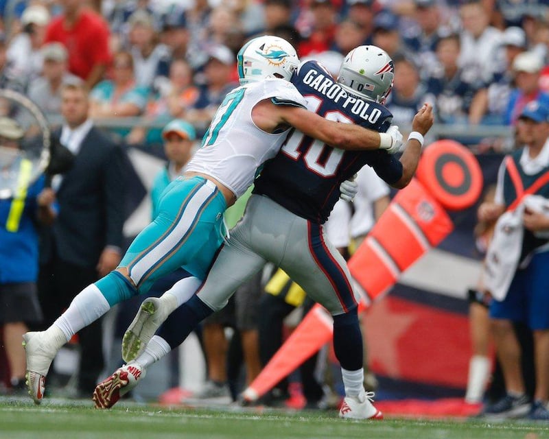 Miami Dolphins linebacker Kiko Alonso hits New England Patriots quarterback Jimmy Garoppolo on Sunday. CJ Gunther / EPA