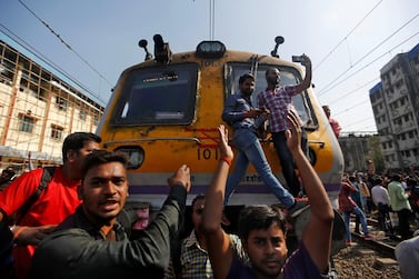 People shout slogans as they block train services during a protest demanding recruitment into the railway services in Mumbai in March. Unemployment rate in India was high even before pandemic wiped out millions of jobs in the country. Reuters