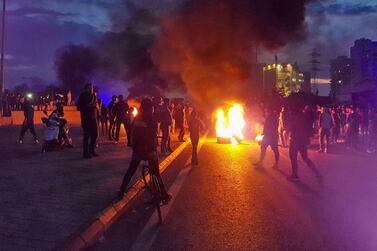 Lebanese anti-government protesters burn tyres to block a road in al-Mina town in the northern port city of Tripoli on December 10, 2019. AFP / Fathi AL-MASRI