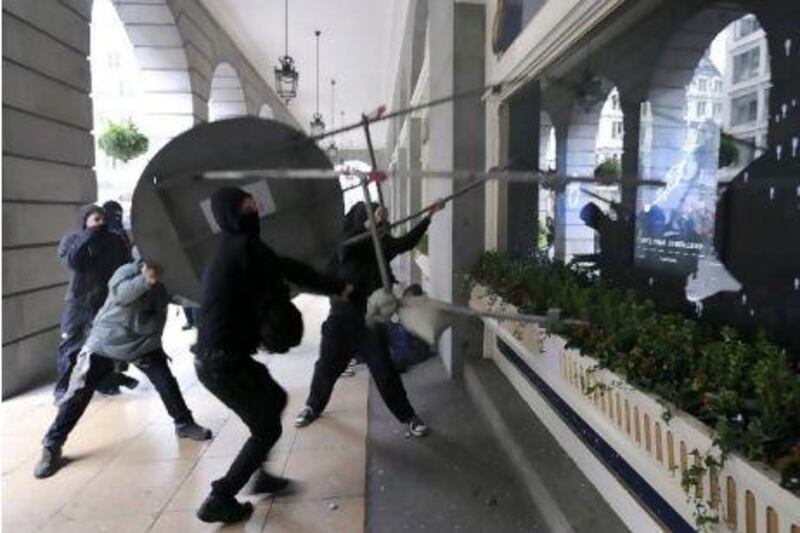 Protesters attack the Ritz Hotel in London after a march on Saturday against the UK government's austerity measures.