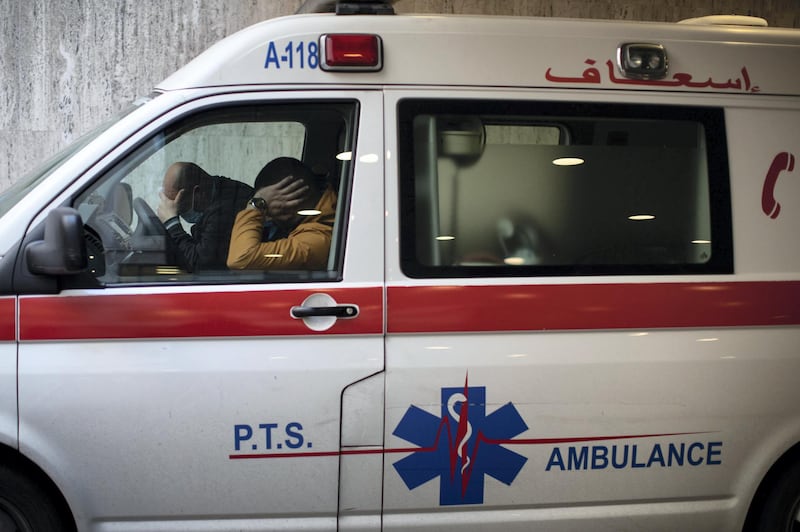 ©2021 Tom Nicholson. 18/01/2021. Beirut, Lebanon. Paramedics rest in an ambulance parked outside the Emergency Department at the American University of Beirut (AUB) Hospital. Deaths in Lebanon from Coronavirus reached a peak high of 55 today. Photo credit : Tom Nicholson