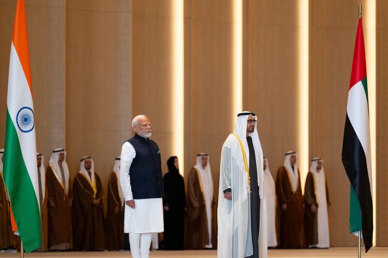 Sheikh Mohamed and Mr Modi stand for the national anthems. Abdulla Al Bedwawi / Presidential Court
