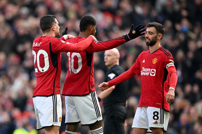 Marcus Rashford celebrates scoring Manchester United's second goal against Everton with teammates Diogo Dalot and Bruno Fernandes at Old Trafford on Saturday, March 9, 2024. Getty Images