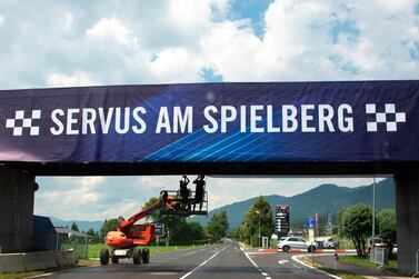 Workers install a banner reading "Welcome to Spielberg" near the entrance to to Red Bull Ring, on July 1, 2020, 4 days ahead of the Austrian Formula One Grand Prix in Spielberg, Austria. Seven months after they last competed in earnest, the Formula One circus will push a post-lockdown ‘re-set’ button to open the 2020 season in Austria on July 5. / AFP / JOE KLAMAR
