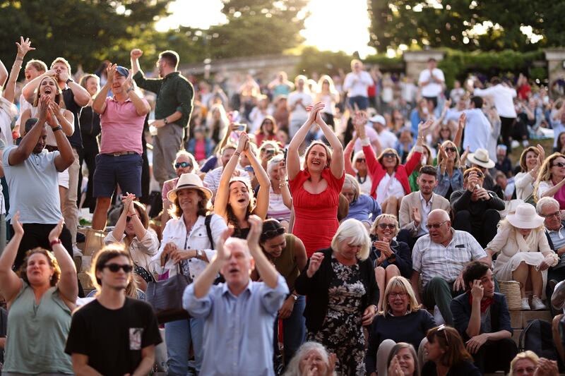 Spectators watch the big screens from The Hill during the men's quarter-final match showcasing Cameron Norrie of Great Britain against David Goffin of Belgium at All England Lawn Tennis and Croquet Club. Getty Images