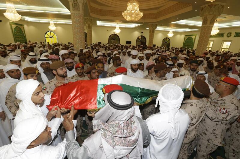 The body of Sgt Khalid Ali Ghareeb Al Baloushi is laid to rest in Dubai. Jeffrey E Biteng / The National