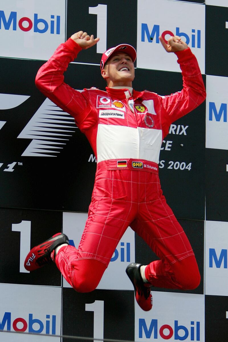 MAGNY-COURS, FRANCE - JULY 4:  Michael Schumacher of Germany and Ferrari celebrates on the podium after winning  the French F1 Grand Prix at the Magny-Cours Circuit on July 4, 2004, in Magny-Cours, France. (Photo by Clive Rose/Getty Images) 