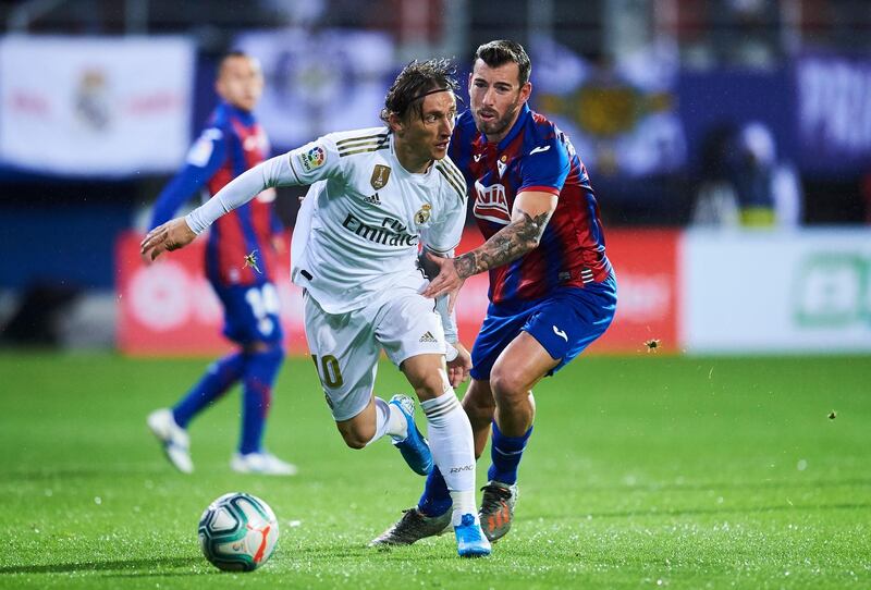 Luka Modric shrugs off the challenge of Sergi Enrich. Getty Images