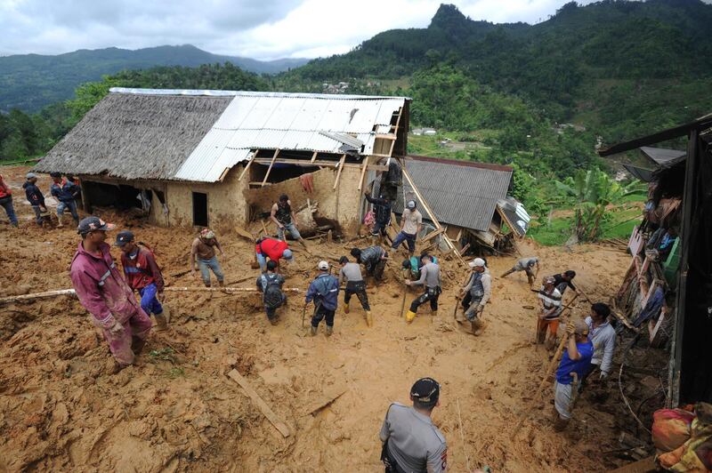 Rescuers search for victims at a village hit by a landslide in Sirnaresmi, West Java, Indonesia.  AP Photo