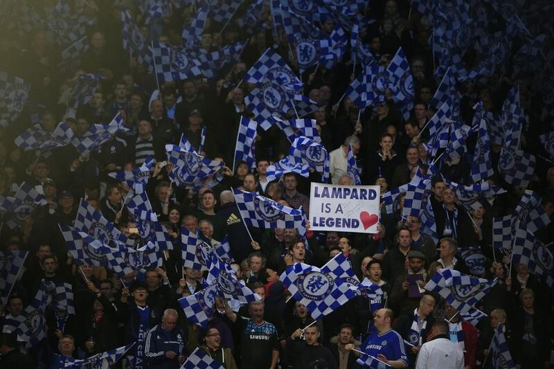 Chelsea fans hold up a sign reading "Lampard is a legend" and flags ahead of Tuesday night's Champions League match between Chelsea and Paris Saint-Germain. Adrian Dennis / AFP / April 8, 2014