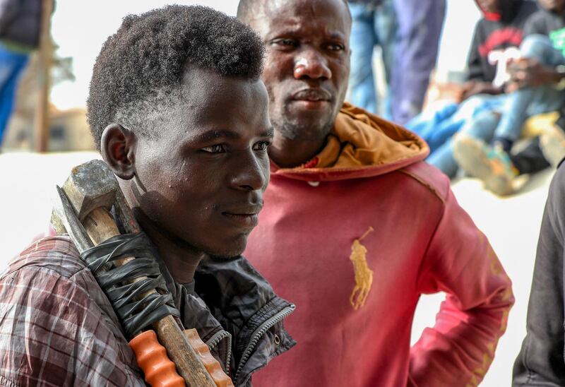 An African migrant day labourer seeking casual work carries his tools on his shoulders in the Libyan capital Tripoli. Migrants, many from Niger, Sudan, Eritrea and other sub-Saharan African countries, gather at dawn underneath bridges in the city in search of employment. AFP