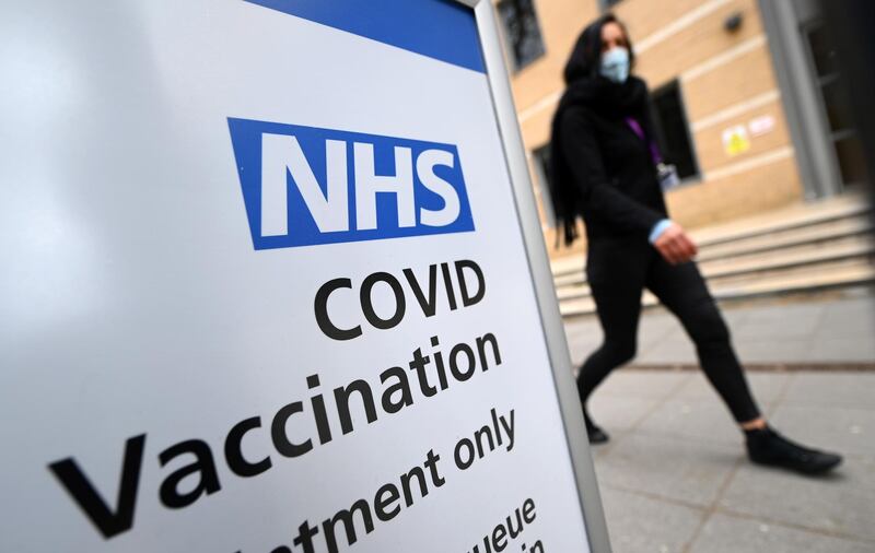 A member of the public passes by a vaccination centre in London. The UK government has been considering the use of vaccine certification. EPA