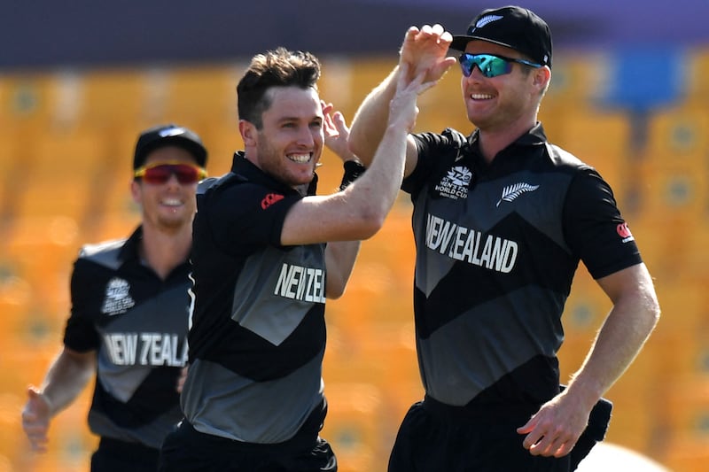 New Zealand's Adam Milne, centre, celebrates with teammates after taking the wicket of Afghanistan's Mohammad Shahzad. AFP