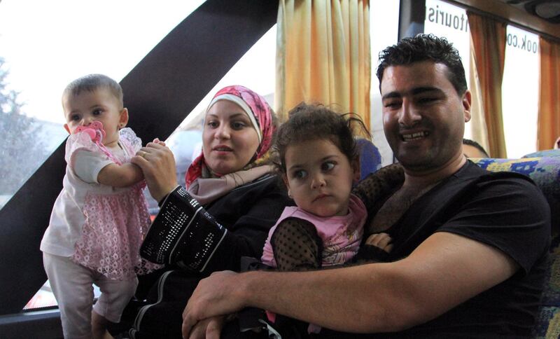 Displaced Syrians and their children are seen on board of buses upon their return from Lebanon to Damascus, Syria.  EPA