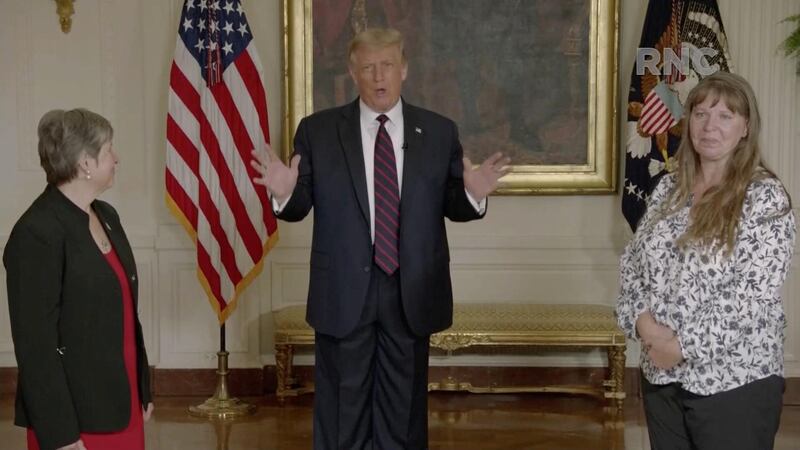 US President Donald Trump, flanked by essential workers, speaks by video feed during the largely virtual 2020 Republican National Convention broadcast from Washington. Reuters