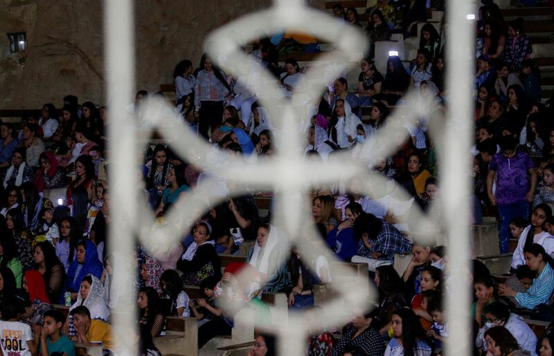 Egyptian Coptic Orthodox Christian worshippers attend the mass in the Samaan El Kharaz Monastery. Reuters