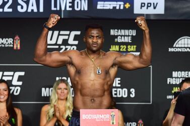 Reigning UFC Heavyweight Champion French Cameroonian mixed martial artist Francis Ngannou flexes during weigh-in at the Anaheim Convention Center in Anaheim, California on January 21, 2022.  (Photo by FREDERIC J.  BROWN  /  AFP)