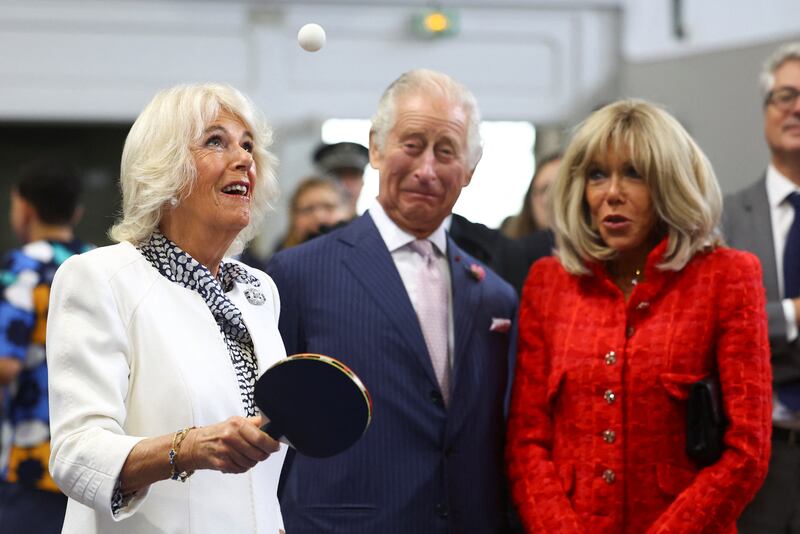 Queen Camilla plays table tennis, watched by King Charles and Brigitte Macron, as they meet local youth sports associations in Saint-Denis near Paris. Getty Images