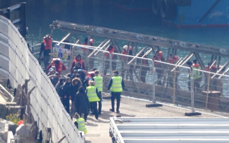 Migrants are taken into Dover, Kent, from a Border Force vessel, from a small boat in the English Channel. PA