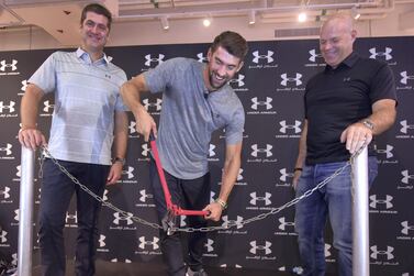 Swimming champion Michael Phelps cuts the chain at the grand opening of the Under Armour store at Dubai Mall. Under Armour