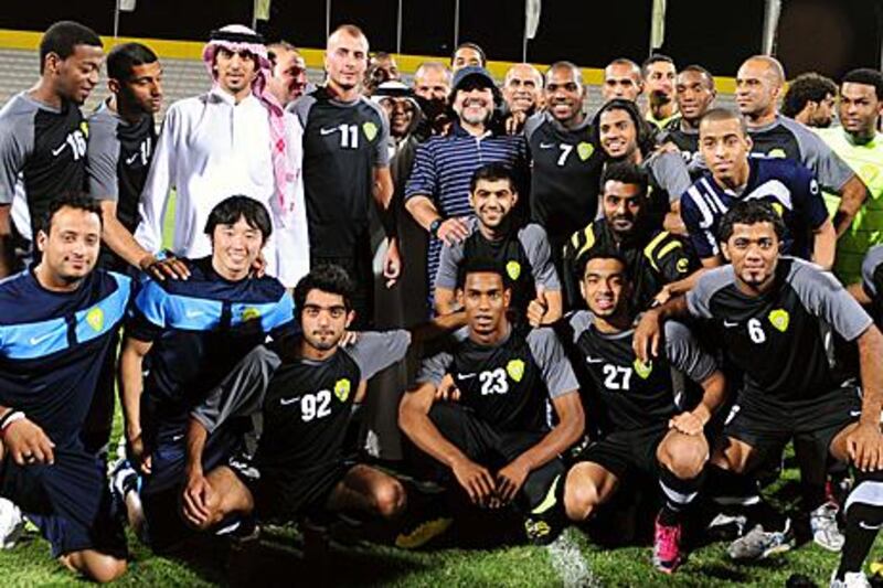 Diego Maradona, centre, poses with the Al Wasl players, who he will take charge of next season, during a recent trip to Dubai earlier this month.