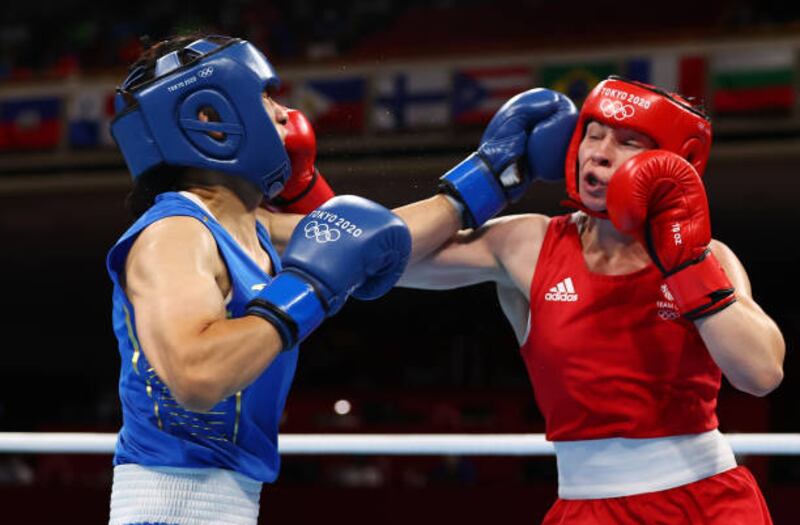 Lauren Price (R) of Team Great Britain and Qian Li of Team China in action during the Women's Middle (69-75kg) Final.
