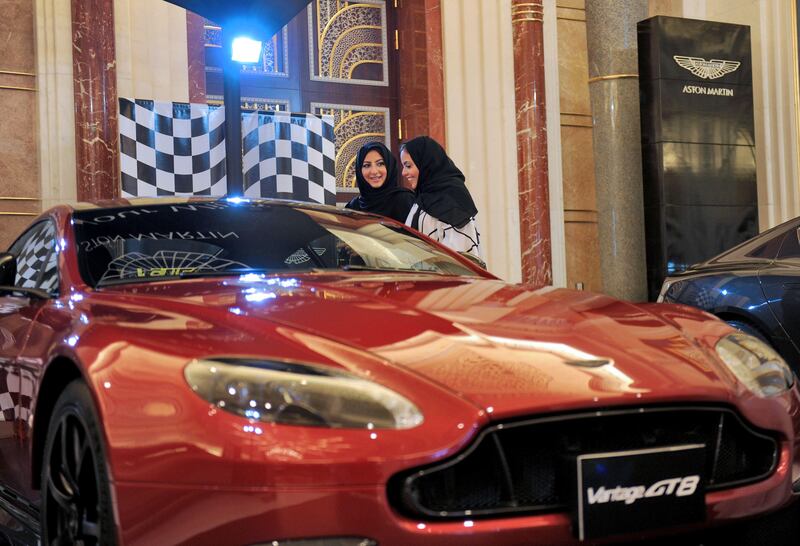 Saudi women check a car at an automobile stand in the Saudi Red Sea resort of Jeddah on October 5, 2017. 
With many carrots and some sticks, ultra-conservative Saudi Arabia seeks to tackle entrenched male attitudes towards women drivers before millions take the wheel, many for the first time, on June 2018. / AFP PHOTO / Amer HILABI