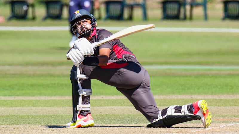 UAE batter Basil Hameed sweeps over fine leg for a boundary. 