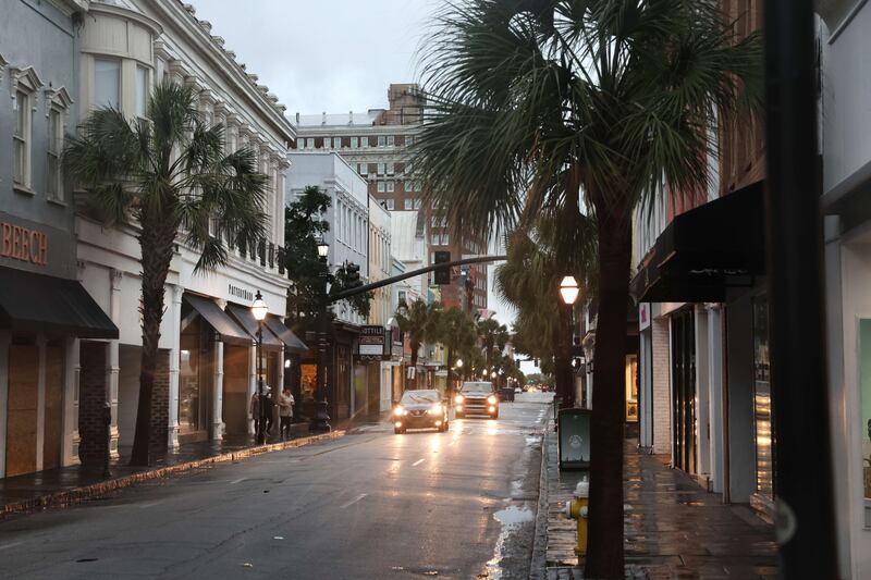 Cars drive through the nearly deserted historic district of Charleston. Getty Images / AFP