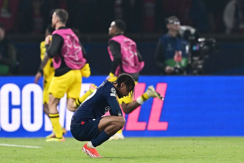 PSG forward Bradley Barcola crouches on the pitch after the defeat to Dortmund. AP