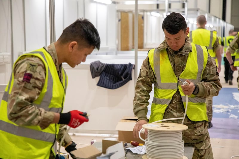 Members of the Queen's Ghurka Engineers Regiment, 36 Engineer Regiment, help to build the new NHS Nightingale Hospital.  REUTERS