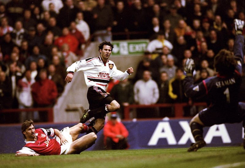 Giggs drives the ball past Arsenal's David Seaman to score the winner in the FA Cup semi-final in May 1999, which helped Manchester United secure a historic 'treble' of trophies - the Premier League, the FA Cup, and the UEFA Champions League. Getty Images