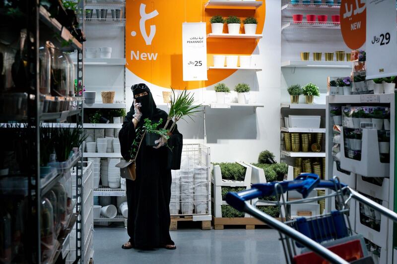 A customer carries plant purchases and uses her mobile phone while shopping in an Ikea AB store in Riyadh, Saudi Arabia, on Tuesday, May 19. 2020. Before the pandemic, most shops, pharmacies and gas stations in the kingdom halted for at least 30 minutes for each prayer session, the only country that enforced such closures. Photographer: Tasneem Alsultan/Bloomberg
