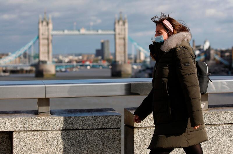 A pedestrian at London Bridge on September 25, 2020. Britain's Prime Minister Boris Johnson announced a host of new restrictions as Covid-19 cases spike. Tolga Akmen / AFP