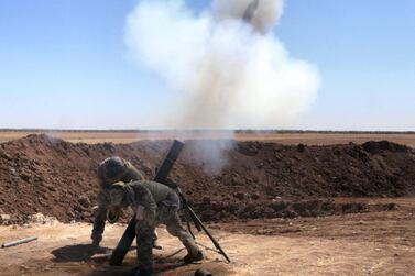 A file photo of Free Syrian Army (FSA) members launching a rocket attack on September 26, 2016. Getty Images