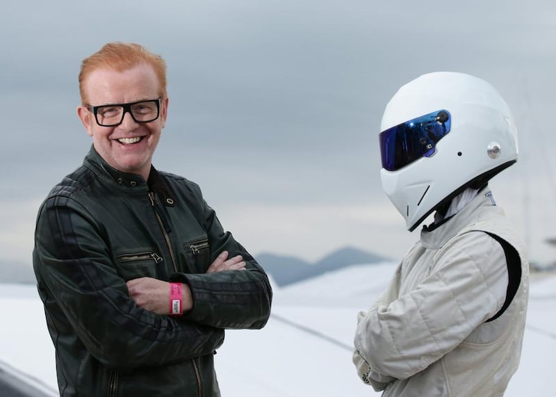 Chris Evans, left, standing with driving show Top Gear's The Stig, is revealed to be the highest paid member of the BBC (Yui Mok/PA/AP)
