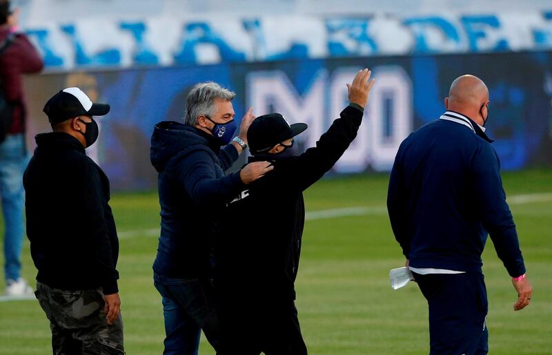 Diego Maradona waves before the match between Gimnasia y Esgrima and Patronato. Reuters