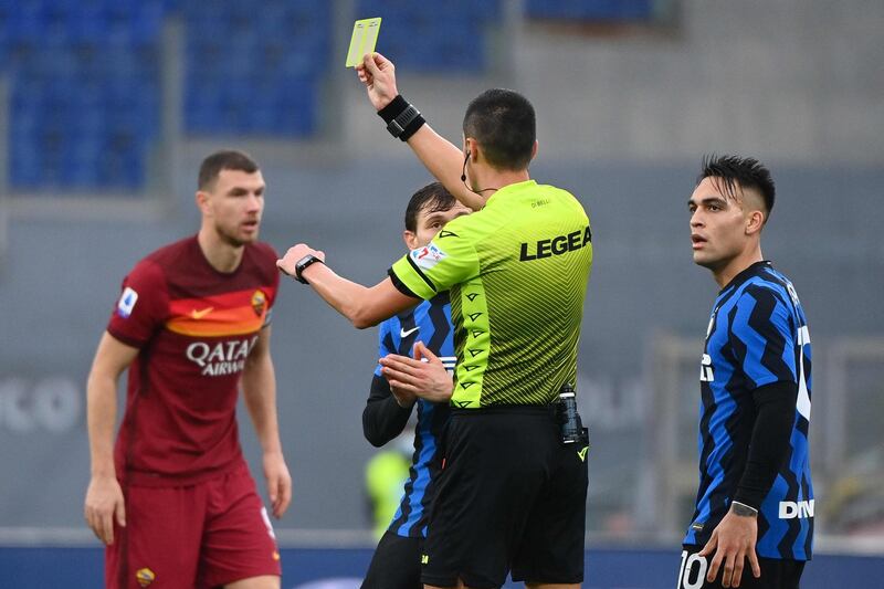 Referee Marco Di Bello gives a yellow card to Inter  forward Romelu Lukaku (not in picture). AFP